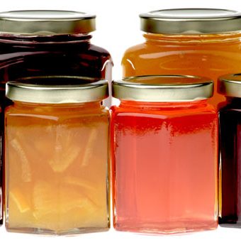 Hexagonal jam jars filled with various jams, marmalades and preserves.